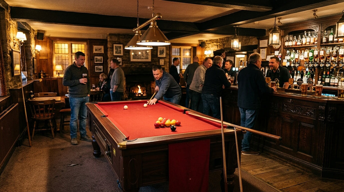 Coin-operated pool table with red cloth in a traditional UK pub