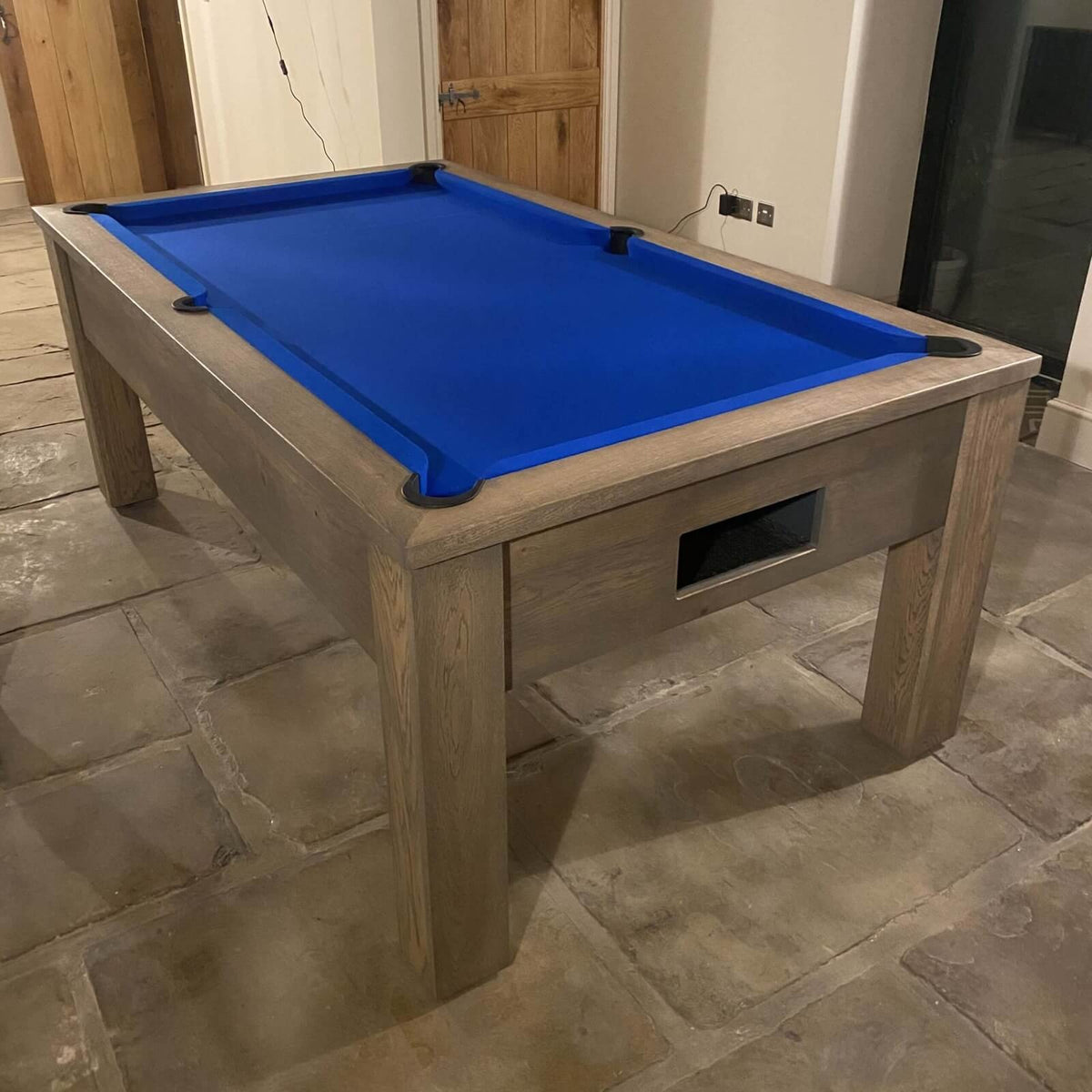 English pool table with blue cloth and a grey oak cabinet in a home