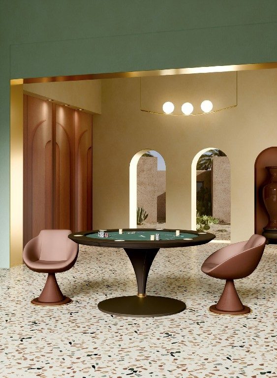 Round Asso poker table with green cloth and a brown leather cone base on a terrazzo floor