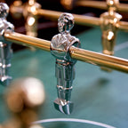 Close-up of gold and chrome B50 players on the green pitch