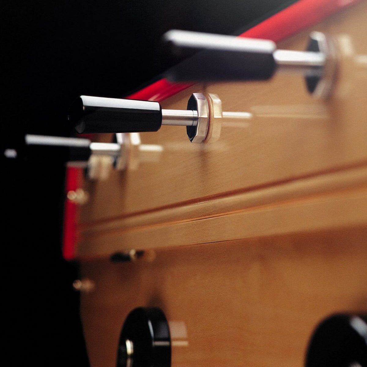 Chrome rods and black handles along the side of the B60 football table