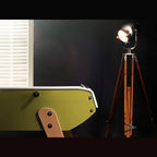 Ochre Eames inspired B90 football table end with beech leg beside a floor lamp