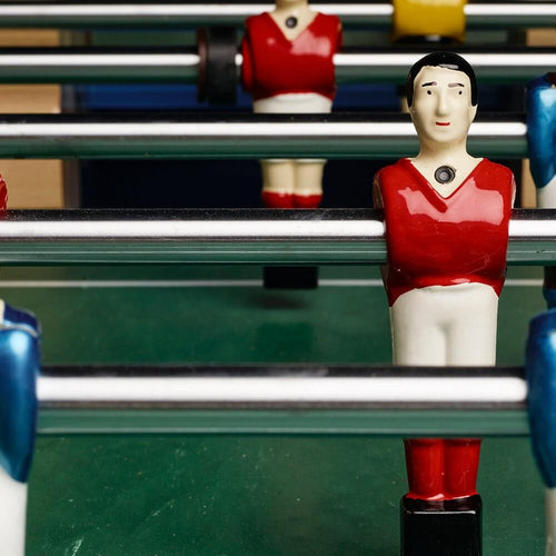 Close-up of red and blue Bonzini B90 players on chrome rods