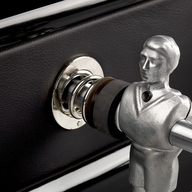 Chrome player and rod bearing against the black leather cabinet
