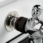 Chrome player and rod bearing against the white leather cabinet