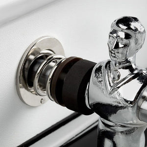 Chrome player and rod bearing against the white leather cabinet