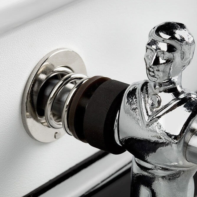 Chrome player and rod bearing against the white leather cabinet