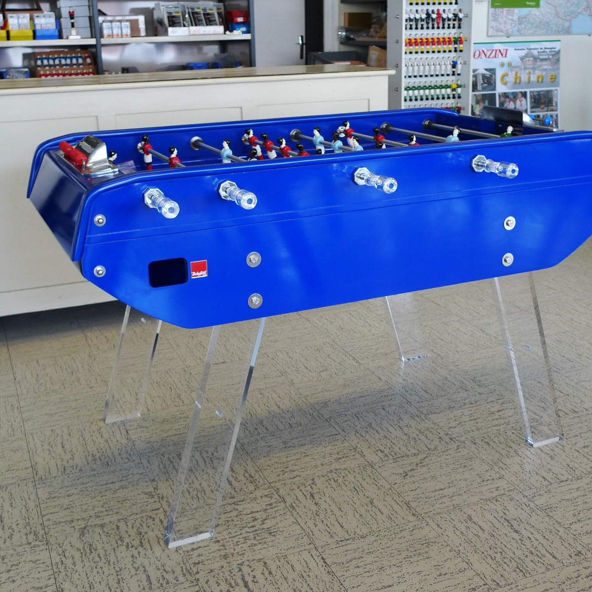 Blue B90 football table with clear Perspex legs in an office
