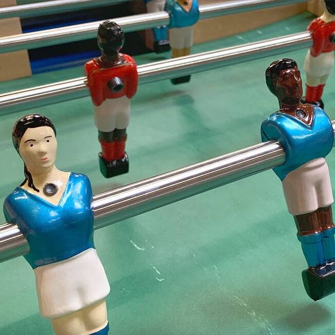 Male and female Bonzini players in blue and red strips on the pitch