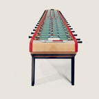 Bonzini Giant 22 player football table in natural beech with red rails and black legs