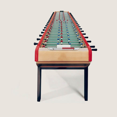 Bonzini Giant 22 player football table in natural beech with red rails and black legs