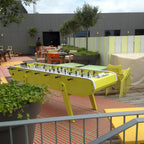 Yellow Bonzini giant football table on an outdoor terrace