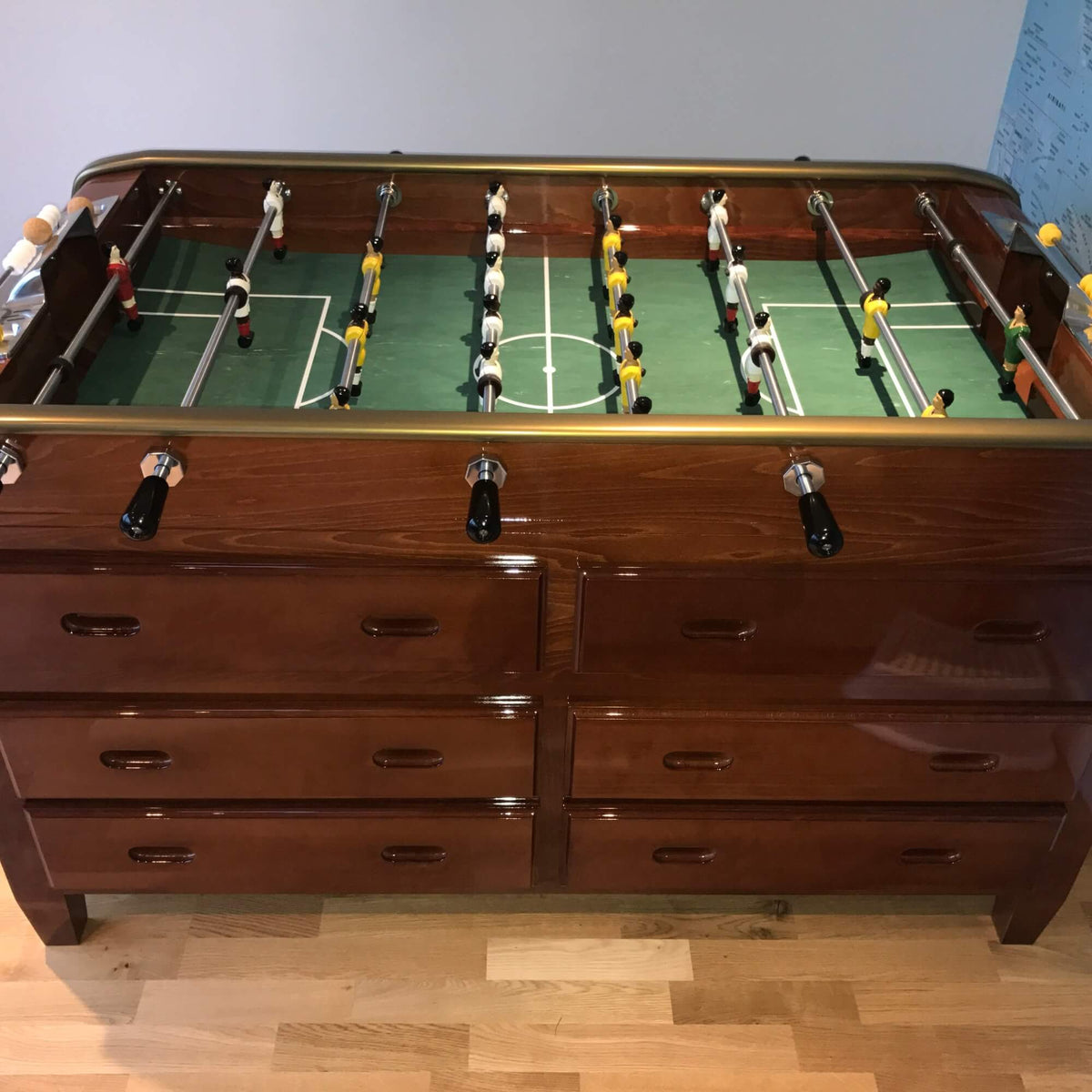 Cherry wood Grand Tiroirs football table with drawers on a wooden floor