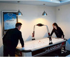 Two players enjoying a game on the Buffalo Hurricane II air hockey table in a games room