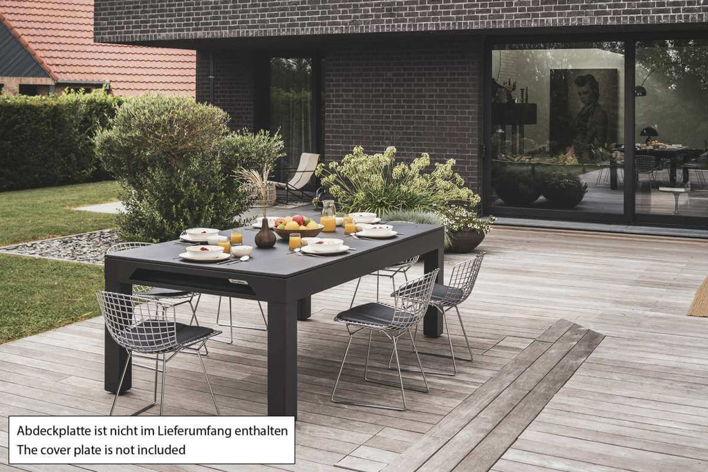 Cornilleau Classic Outdoor Pool Dining Table in Charcoal Grey frame set up outdoors on a patio