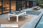 Cornilleau Classic Outdoor Pool Dining Table in White frame outdoors, further angle showing the table in its setting