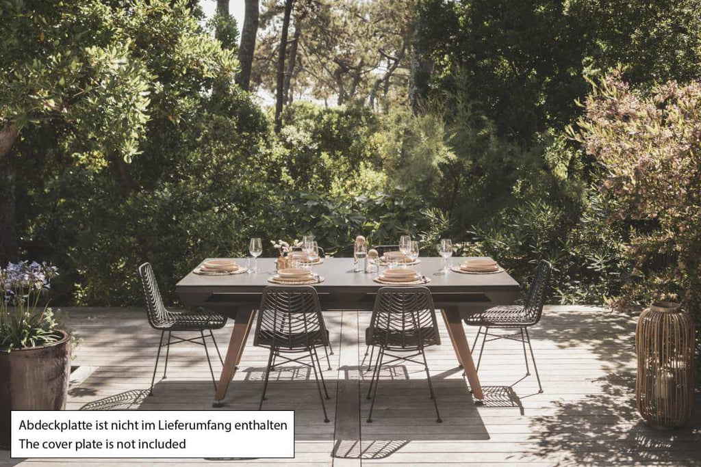 Black Cornilleau Origin outdoor dining pool table set up outside with the dining top fitted