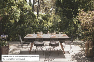 Black Cornilleau Origin outdoor dining pool table set up outside with the dining top fitted