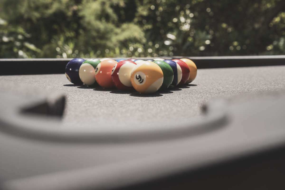 Black Cornilleau Origin outdoor pool table positioned outdoors on a patio
