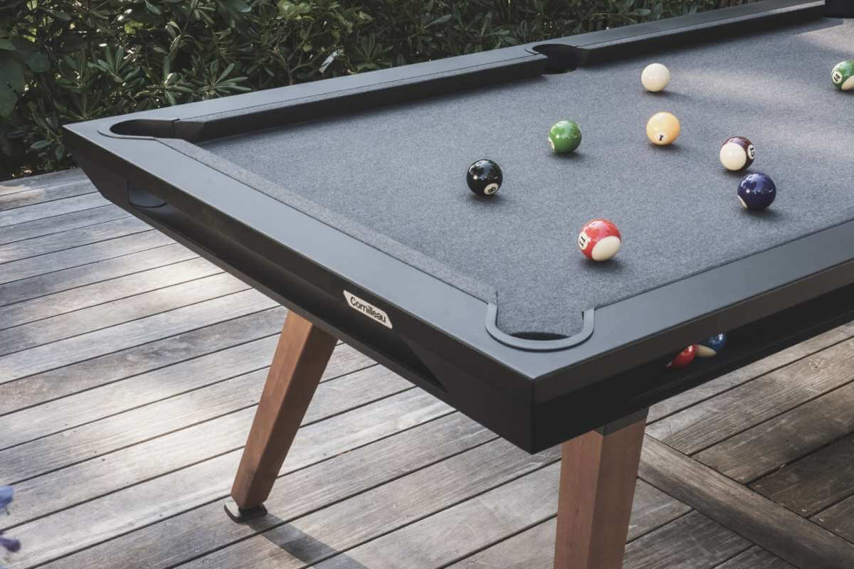 Black Cornilleau Origin outdoor pool table set up outside on a patio