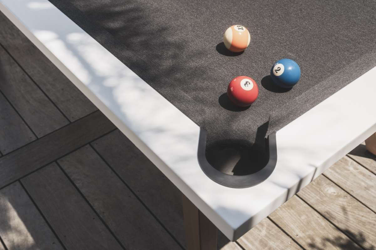 White Cornilleau Origin outdoor pool table racked up with balls ready to play