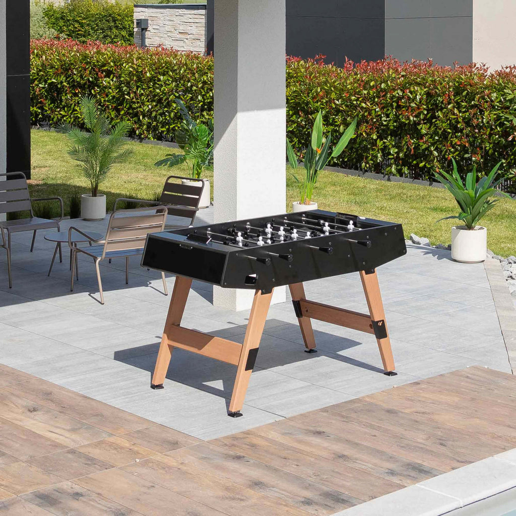 Cornilleau Origin black football table on a garden patio