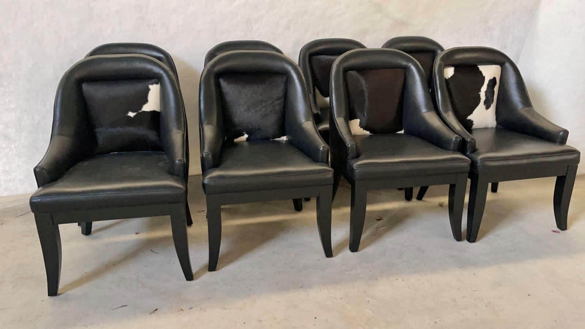 Set of black leather poker chairs with black and white cowhide backs