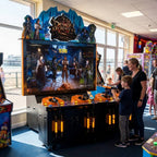Demon Hunter 1892 shooting arcade machine in a UK seaside arcade with a child playing