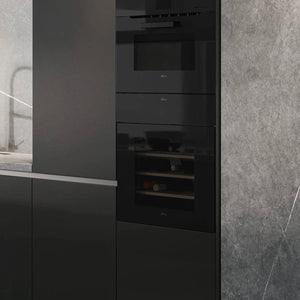 Close-up of the Veritas BI24 black glass front in a column of kitchen units