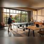 Two people playing on a green Heemskerk indoor table tennis table in a home office
