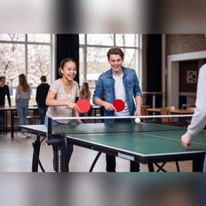 Two students playing on a green Heemskerk 2250 indoor table tennis table at school