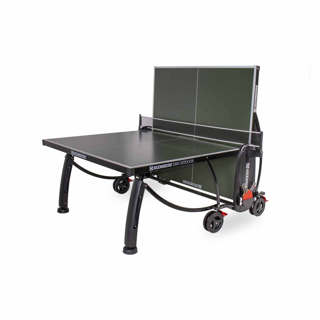 Green Heemskerk 2300 outdoor table tennis table with one half raised for solo practice