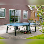Blue Heemskerk 2300 outdoor table tennis table on a patio outside a house