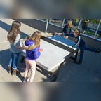 Children playing on a Heemskerk Beta concrete outdoor table tennis table