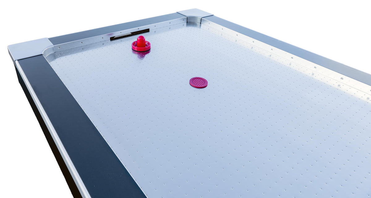 Puck on the stainless steel playfield of the Heemskerk Coliseum air hockey table