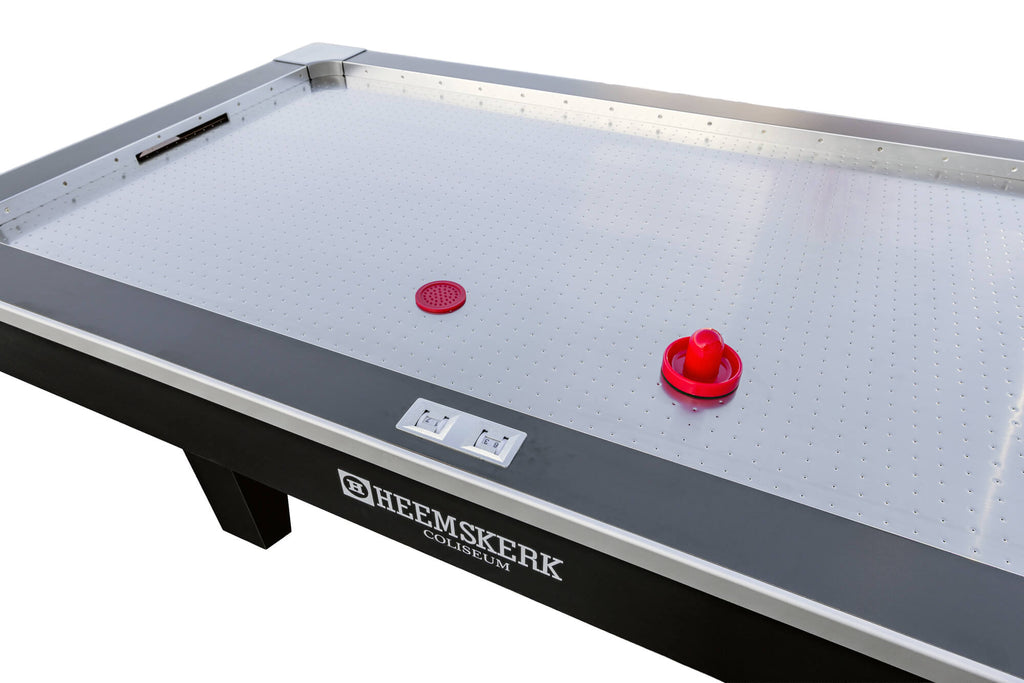 Red pucks and pushers on the Coliseum playfield next to the built-in score counter
