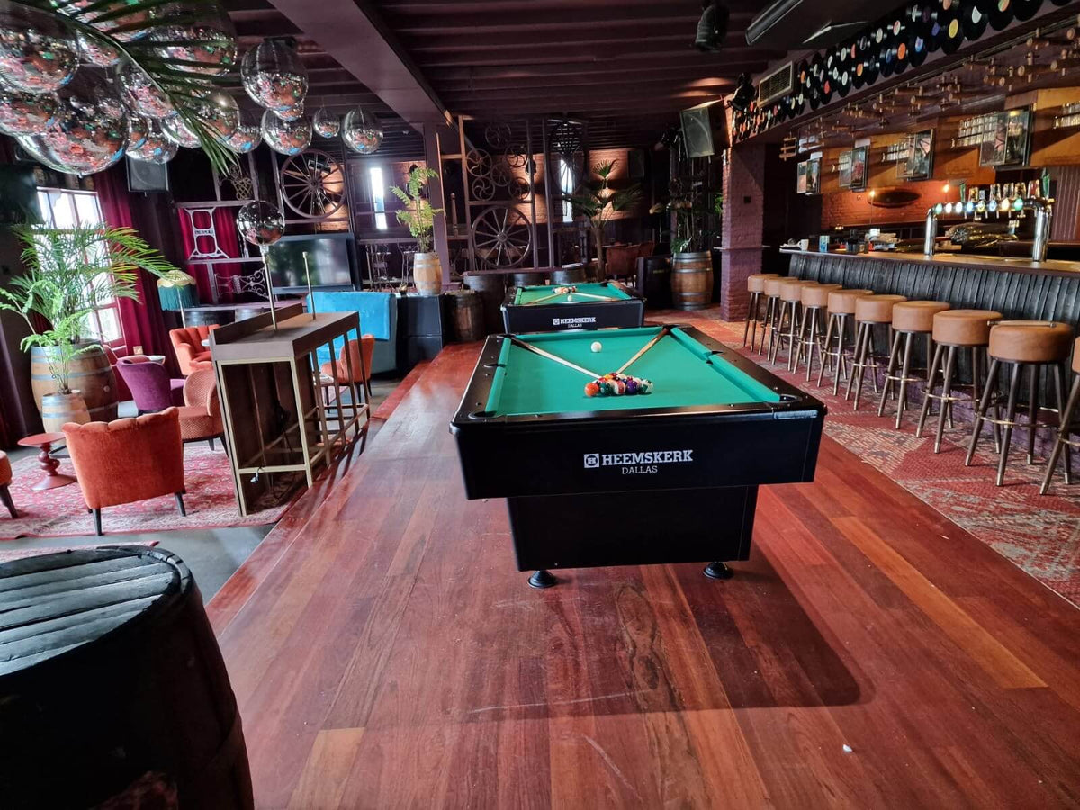 Heemskerk Dallas pool table with green cloth in a bar with wooden floors