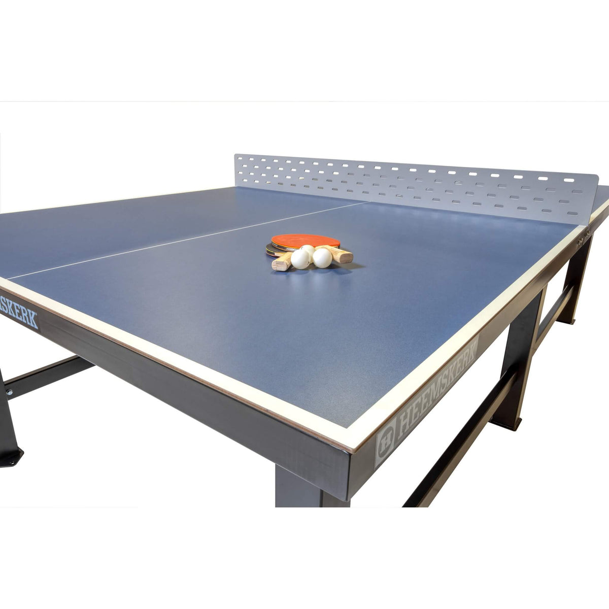 Bats and balls on the blue top of a Heemskerk Delta outdoor table tennis table