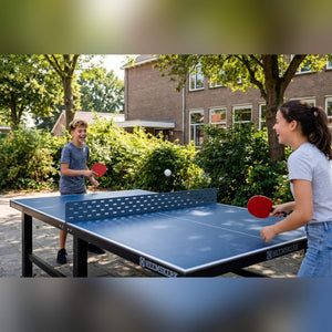Two children playing on a Heemskerk Delta outdoor table tennis table in a schoolyard