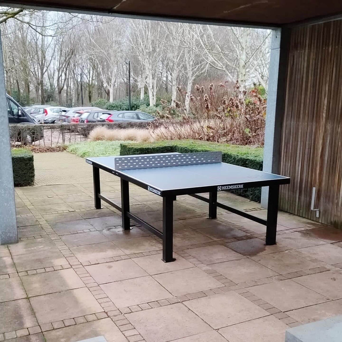Heemskerk Delta outdoor table tennis table on paving under a covered shelter