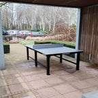 Heemskerk Delta outdoor table tennis table on paving under a covered shelter