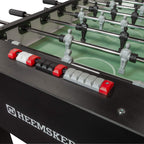 Score counter and rods on the black cabinet of the Heemskerk King Pro foosball table
