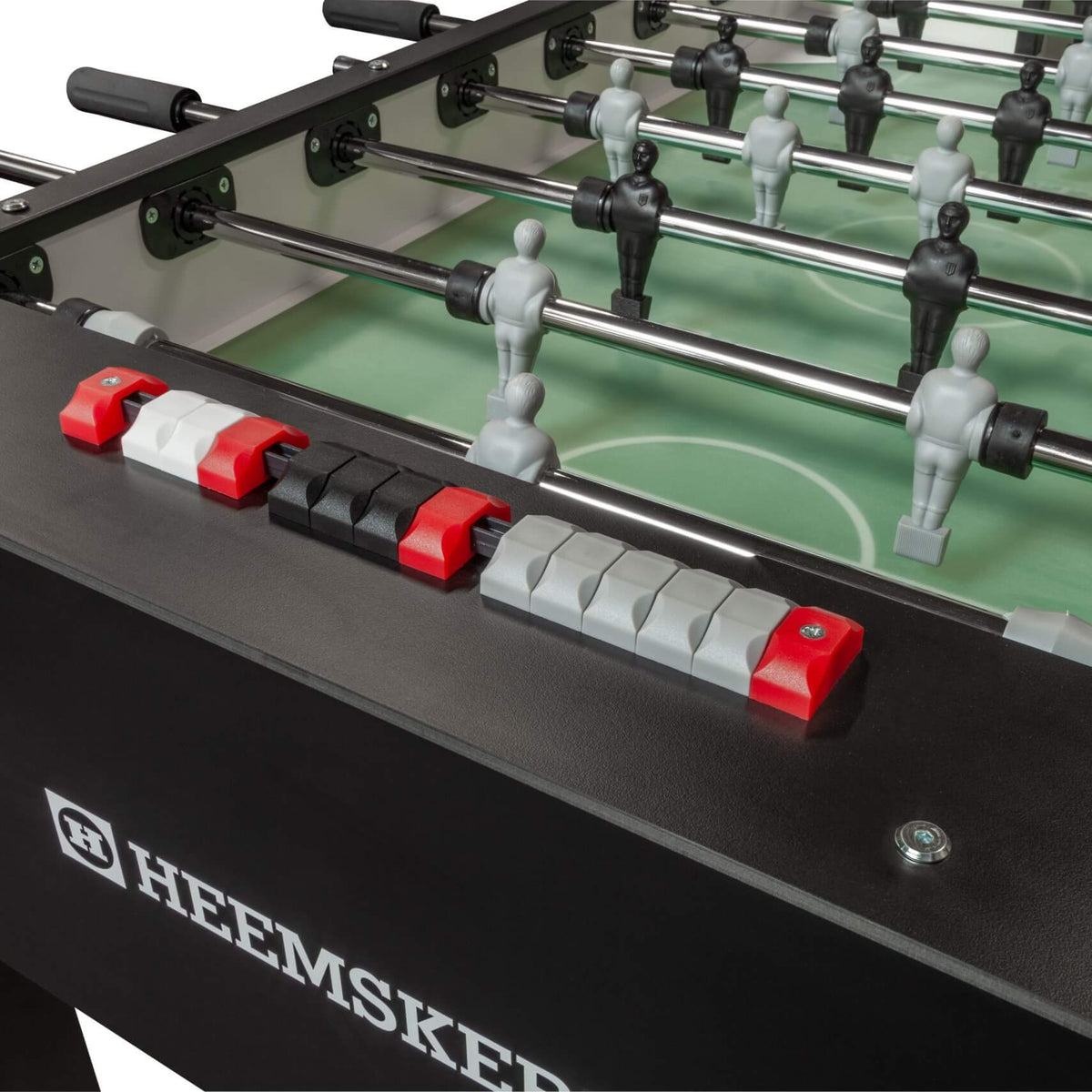 Score counter and rods on the black cabinet of the Heemskerk King Pro foosball table