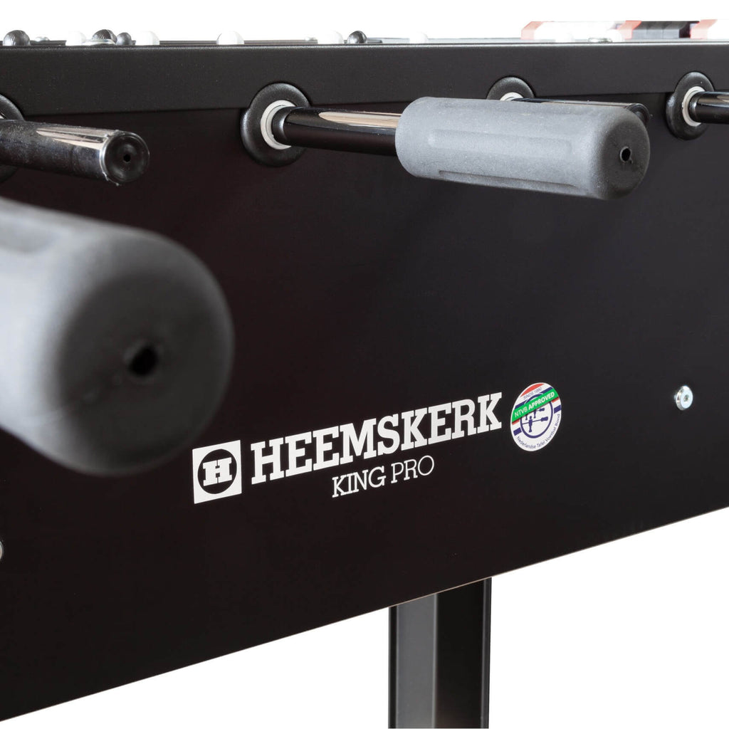 Grey handle and ball return on the side of the Heemskerk King Pro foosball table