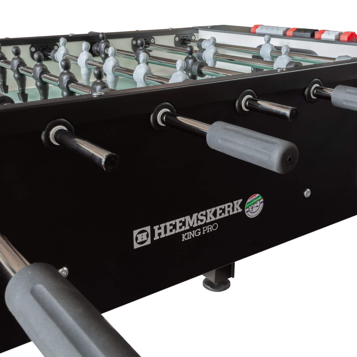 Handles and ball return on the black cabinet of the Heemskerk King Pro foosball table