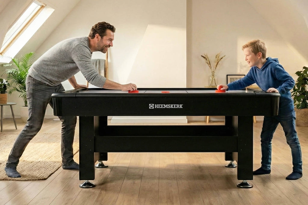 Father and son playing on the Heemskerk Masterplay air hockey table at home