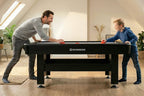 Father and son playing on the Heemskerk Masterplay air hockey table at home