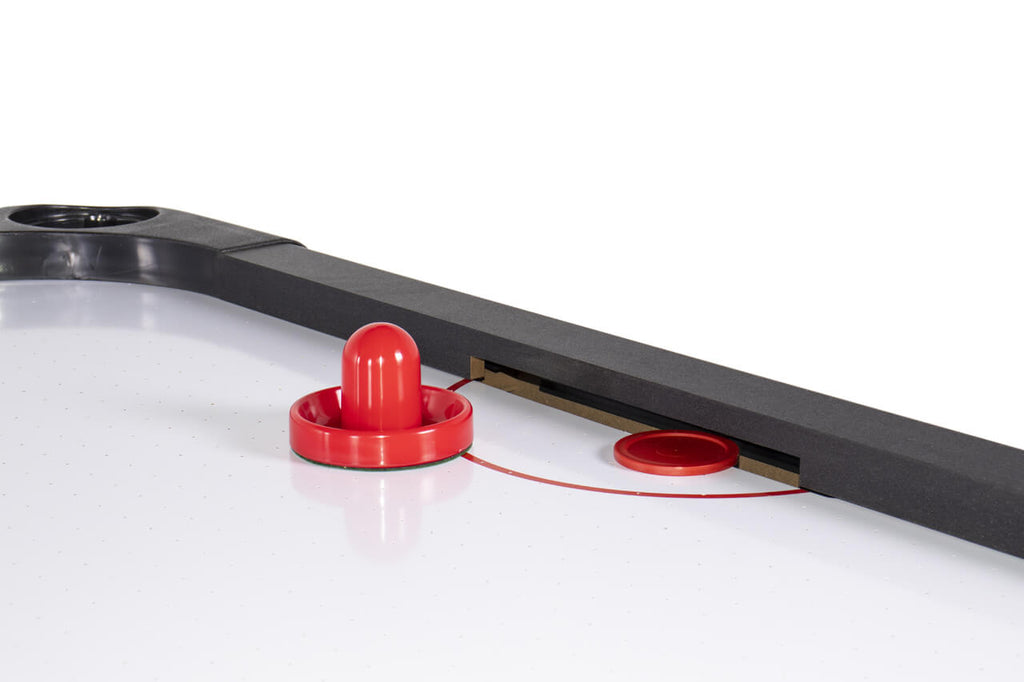 Red pusher next to the goal on the Heemskerk Masterplay air hockey table