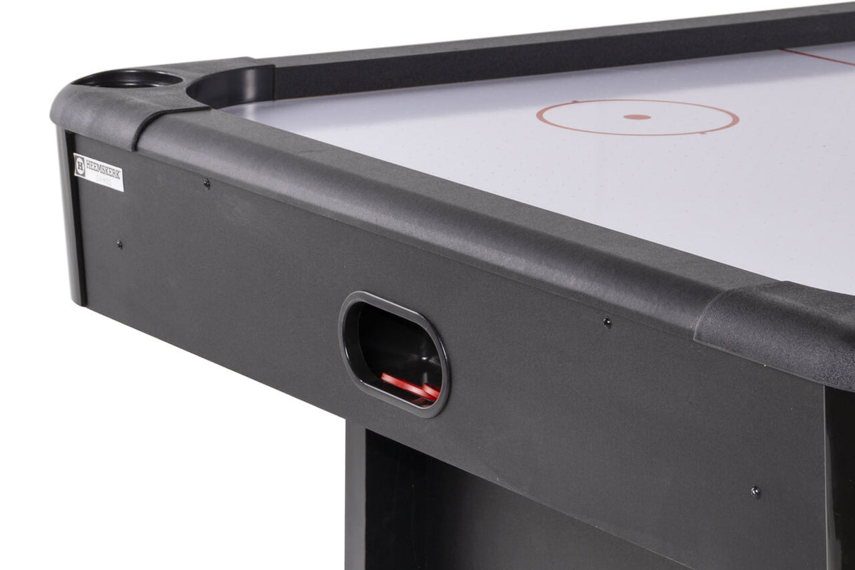 Puck return slot at the end of the Heemskerk Masterplay air hockey table