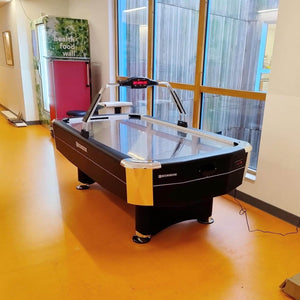 Heemskerk Navona air hockey table by tall windows in a break room